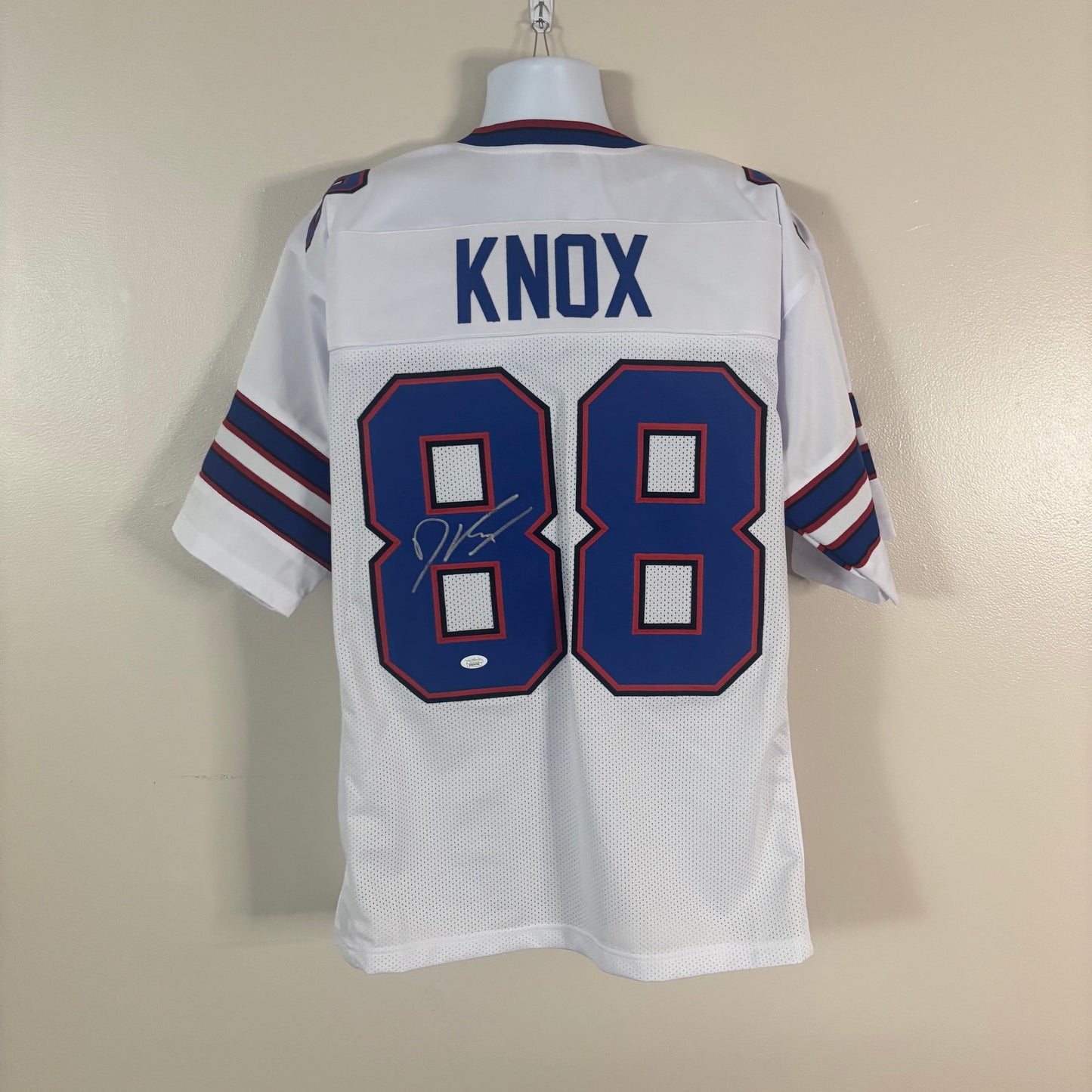 A white Buffalo Bills football jersey with the number 88 and the name 'KNOX' signed on the back.